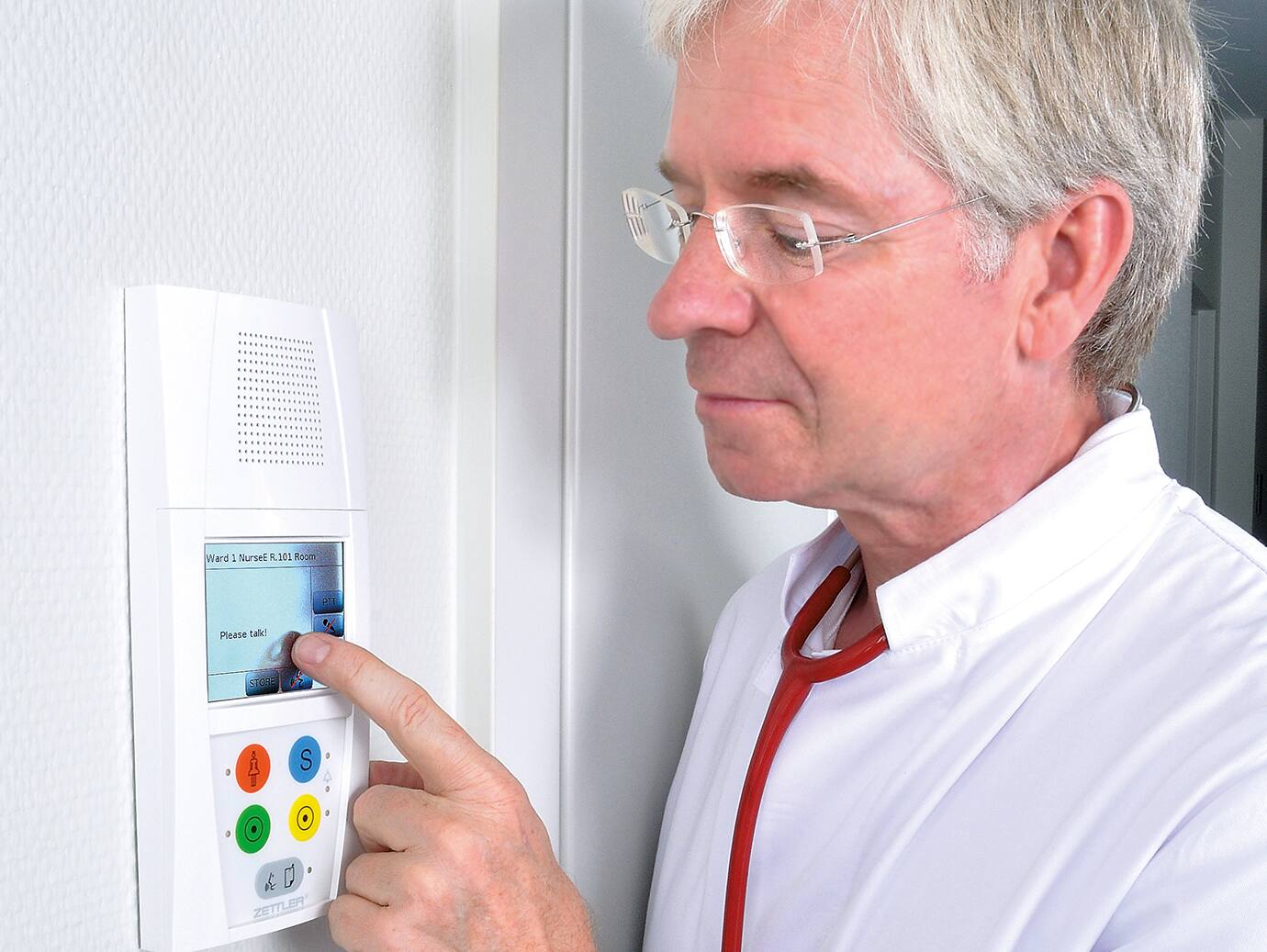 A doctor using a communication device in a hospital