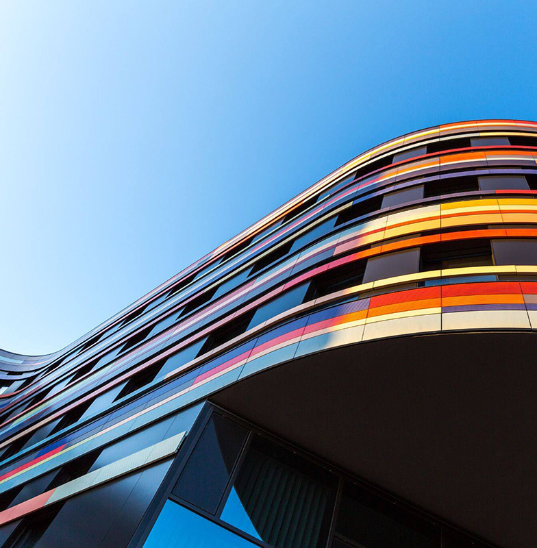 Frog's eye view of a modern, curved building