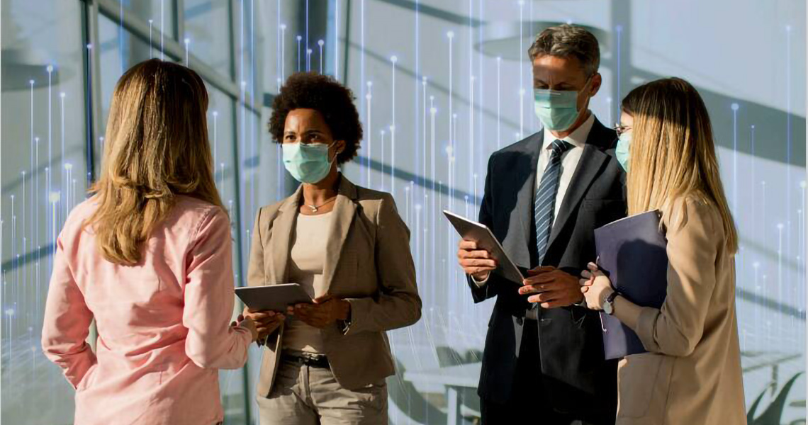 Four people wearing masks having a conversation in a lobby with an overlay of openblue graphics