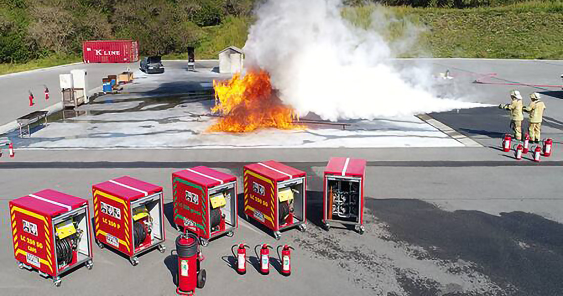 Firefighters putting out a blaze in a drill using various fire suppression systems