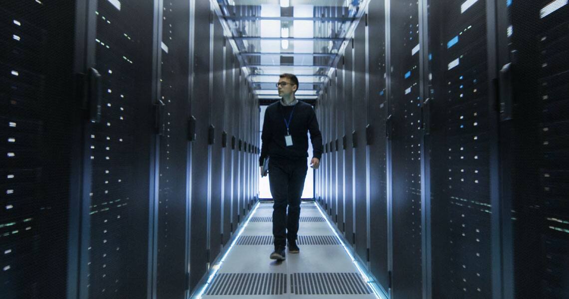 Man walking inside a data center